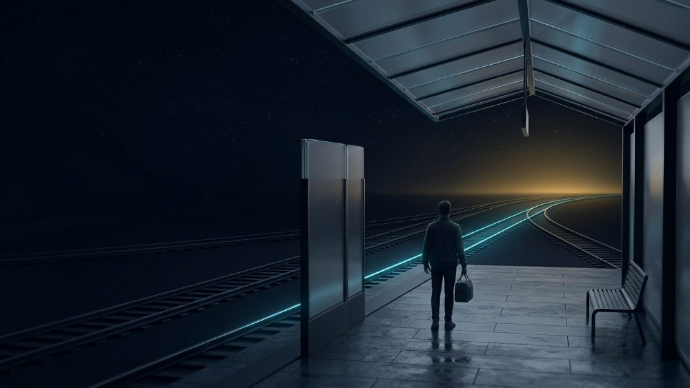 A traveller on a night platform where one glowing rail line leads toward a warm horizon